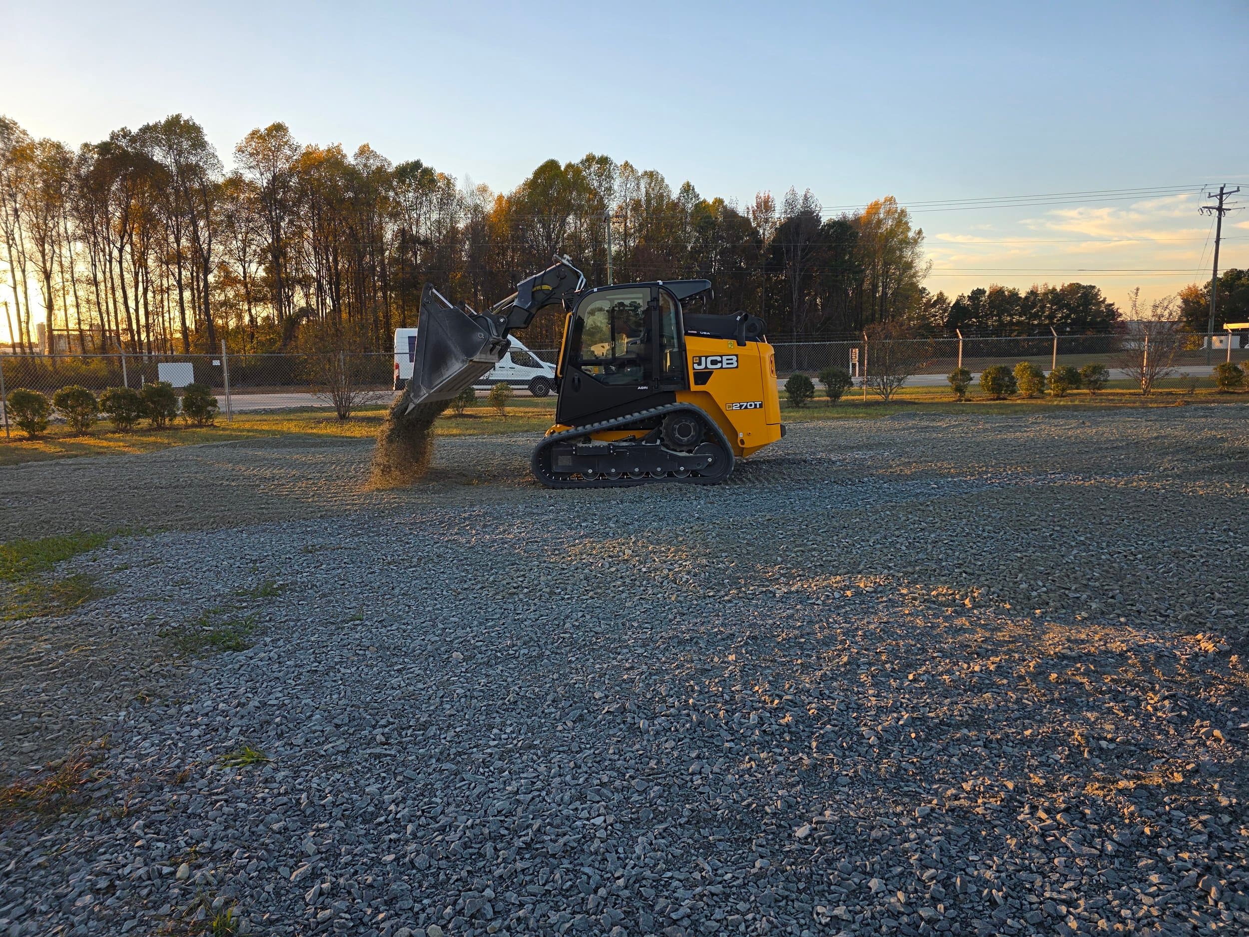 Spreading & grading stone base at golden hour